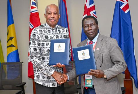 Professor Sir Hilary Beckles, Vice-Chancellor of The UWI, and Professor Andrew Haruna, Secretary General of CVCNU, seal the agreement with a handshake