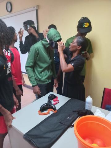 Photo 1 Students wearing impairment-simulation goggles to experience the effects of illicit substance use during an awareness activity facilitated by Paulavette Atkinson, Substance Abuse Prevention Officer a (1)