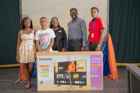 Deputy Principal Timothy Barrett (second right) and students from The Combermere School receive the prize for the secondary school with the highest participation from corporate sponsor representative Ms. Shontell Brooks (centre), Community Relations Coordinator, Barbados Public Workers’ Co-operative Credit Union.