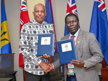 Professor Sir Hilary Beckles, Vice-Chancellor of The UWI, and Professor Andrew Haruna, Secretary General of CVCNU, seal the agreement with a handshake